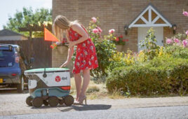 Woman picks item from Cartken last mile delivery robot