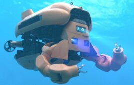 underwater image of the Nauticus sea robot with its arms extended in front of it, ready to grasp something.