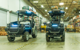 Hero image of two monarch all electric tractors sitting at the end of the production line, ready to be shipped to customers.