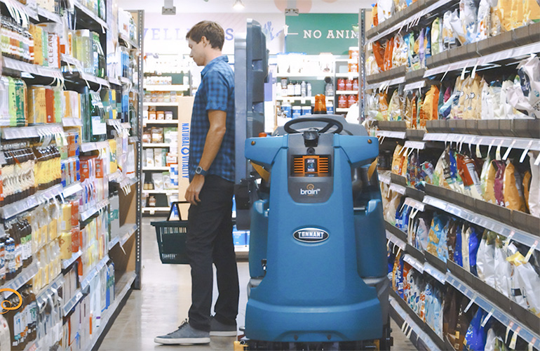 brain corp retail scanning robot in a retail store aisle.
