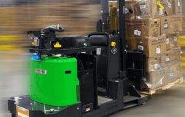 Vecna automated fork truck moving a full pallet through a warehouse.